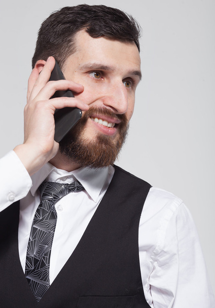 Businessman walking and talking on the phone over white background - Valokuva, kuva