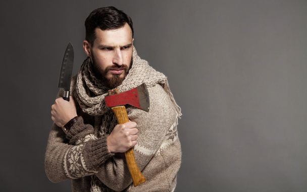Bearded man with ax on grey background. - Foto, imagen