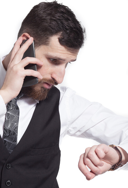 Businessman walking and talking on the phone over white background - Foto, Imagem
