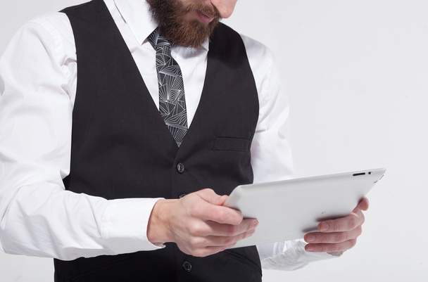 Portrait of a bearded business man using a tablet. On white background. - Foto, afbeelding