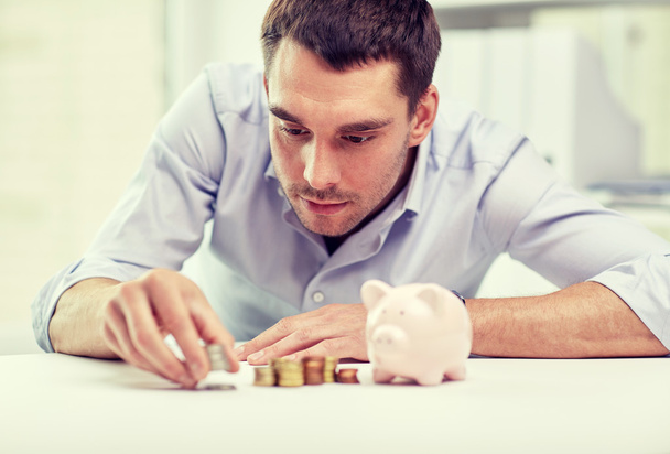 businessman with piggy bank and coins  - Photo, Image