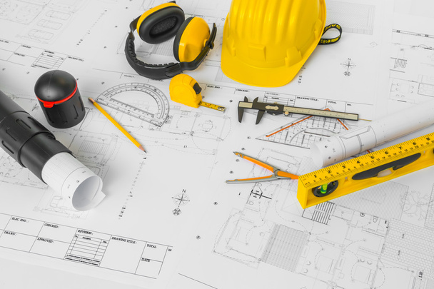 Planes de construcción con casco amarillo y herramientas de dibujo en bluep
 - Foto, Imagen