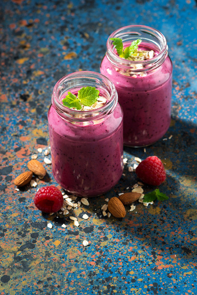 healthy berry smoothie in a bottle on a dark background - Фото, зображення