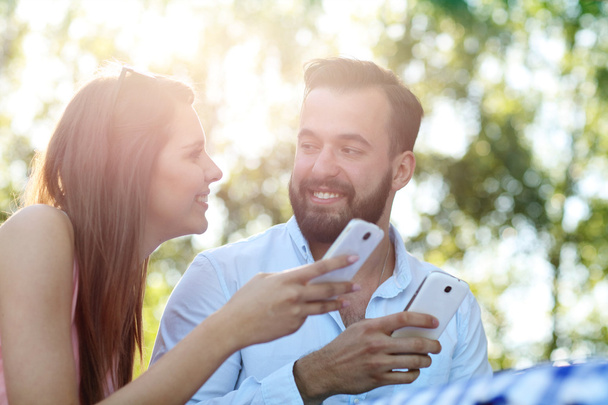 Romantic couple using smartphones  - Foto, immagini