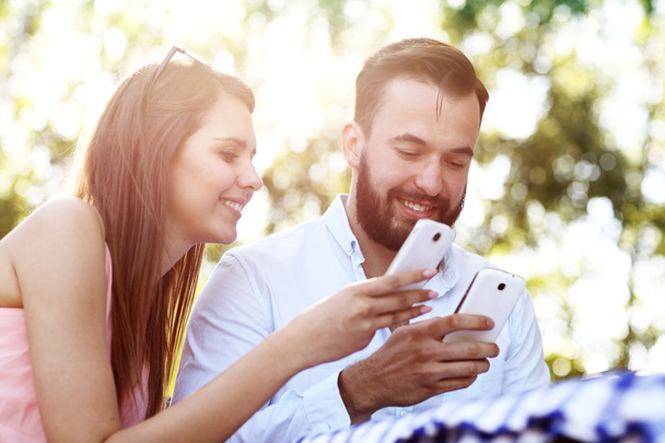 Romantic couple using smartphones  - Foto, Imagem