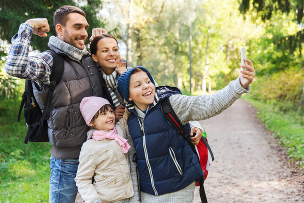 family with backpacks taking selfie by smartphone - Fotoğraf, Görsel