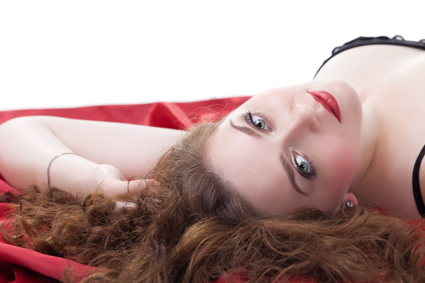 Woman lying on red sheet - Foto, Imagem