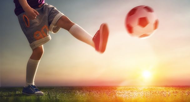 Child plays football - Фото, изображение