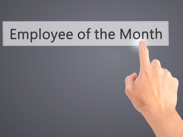 Employee of the Month - Hand pressing a button on blurred backgr - Photo, Image