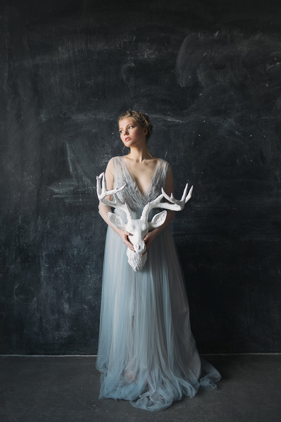 Young beautiful bride in wedding dress posing in studio - 写真・画像