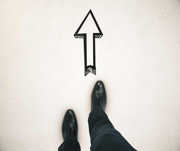 Guidance concept with businessman feet and arrow sketch showing direction on light ground - Photo, Image