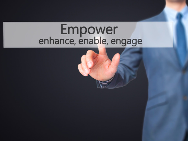 Empower enhance, enable, engage - Businessman hand pressing butt - Fotó, kép
