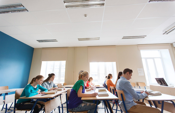 group of students with books writing school test - Zdjęcie, obraz