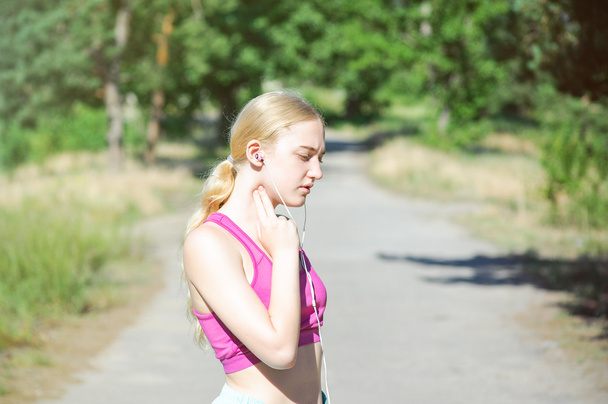 Young girl running in the morning in city park. Healthy fitness  - Фото, зображення