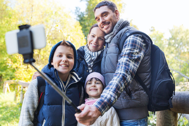 family with backpacks taking selfie and hiking - Fotó, kép