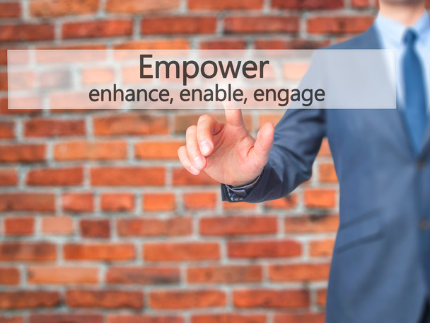 Empower enhance, enable, engage - Businessman hand pressing butt - Fotó, kép