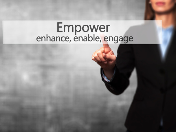 Empower enhance, enable, engage - Businesswoman hand pressing bu - Photo, Image