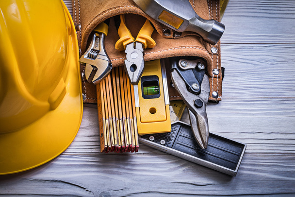 Protective hard hat tool belt on wooden board construction conce - Φωτογραφία, εικόνα