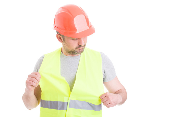 Joven constructor con casco naranja con chaleco de seguridad
 - Foto, Imagen