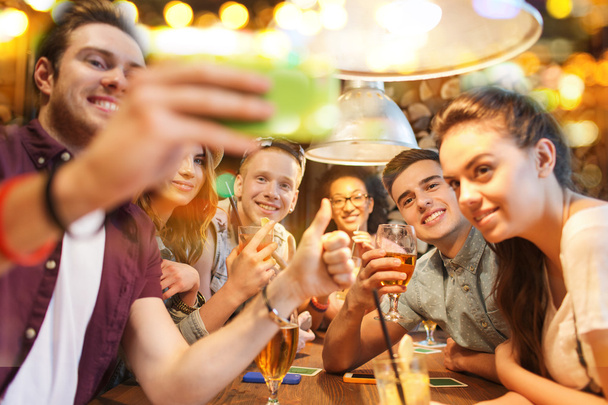 happy friends with smartphone taking selfie at bar - Φωτογραφία, εικόνα