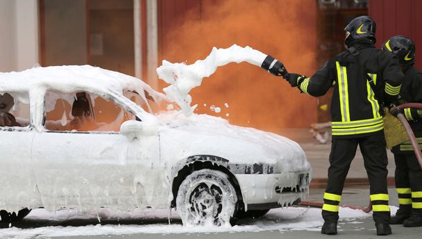 firefighters during exercise to extinguish a fire in a car - 写真・画像