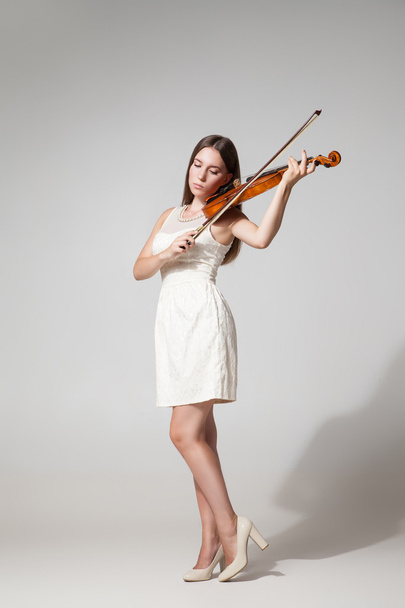 Beautiful young woman playing violing - Foto, afbeelding