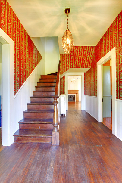 Image of Hallway with wooden staircase and red pattern wallpaper - Zdjęcie, obraz