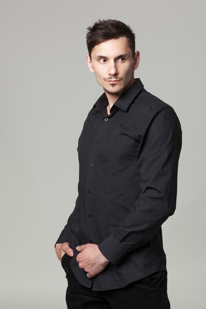 Studio portrait of handsome elegant young man in black  clothes  - Foto, imagen