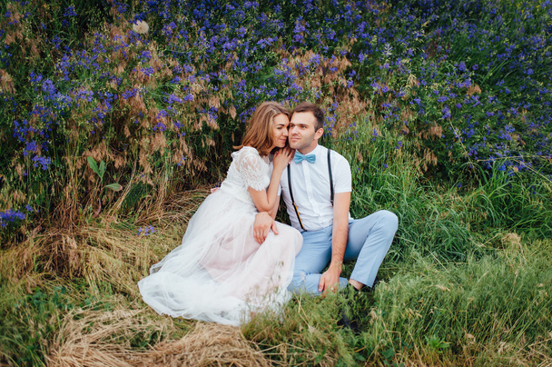 Happy Bride and groom walking on the green grass - Zdjęcie, obraz