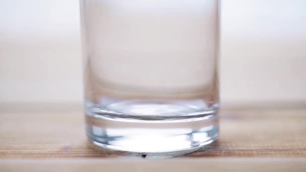 hand pouring milk into empty glass  - Video, Çekim