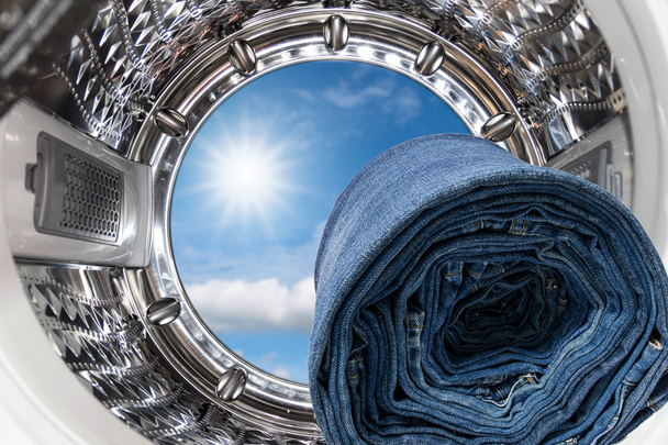 Blue jeans inside the washing machine. - Photo, Image
