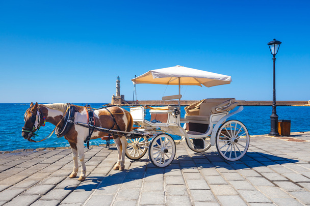 Конный экипаж для перевозки туристов в старом порту Ханья на Крите, Греция
 - Фото, изображение