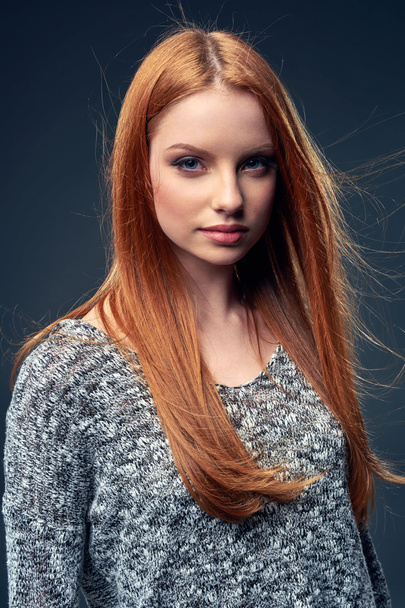 Beautiful red haired female in grey sweater - Foto, imagen