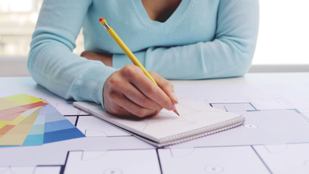woman with blueprint drawing to notebook - Footage, Video