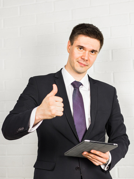 Businessman showing OK sign with his thumb up. - Foto, immagini