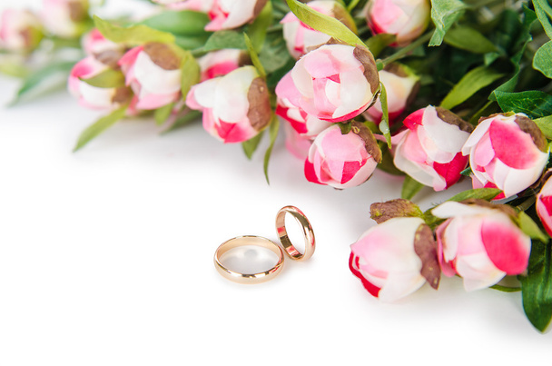 Wedding rings and flowers isolated on white background - Photo, Image