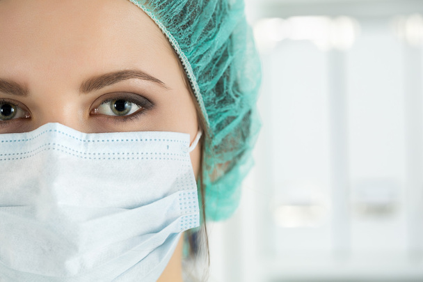 Close-up portrait of young female surgeon doctor  - Фото, изображение