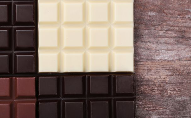 Different chocolate bars on background - 写真・画像