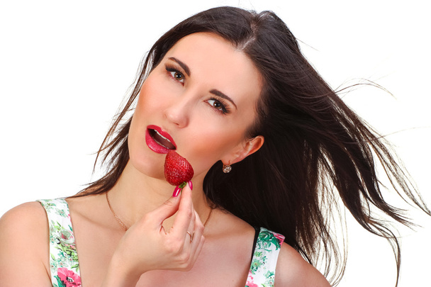 Pretty woman with strawberry in hand isolated on white - Fotografie, Obrázek