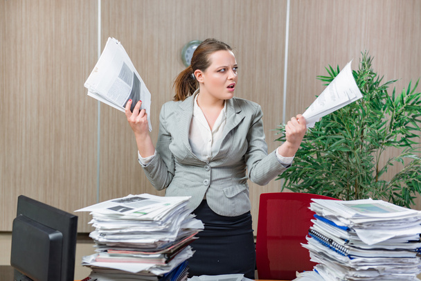 Woman under stress from excessive paper work - Photo, Image