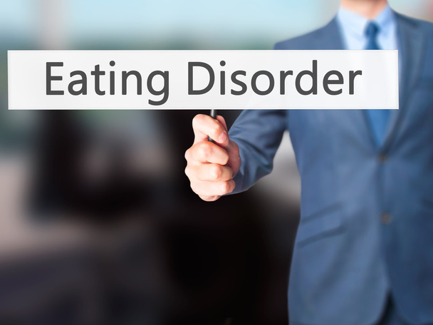 Διατροφική διαταραχή - επιχειρηματίας χέρι κρατάει πινακίδα - Φωτογραφία, εικόνα