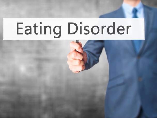Eating Disorder - Businessman hand holding sign - Photo, Image