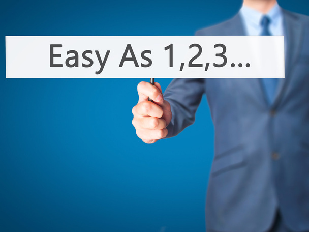 Easy As 1,2,3... - Businessman hand handing sign
 - Фото, изображение