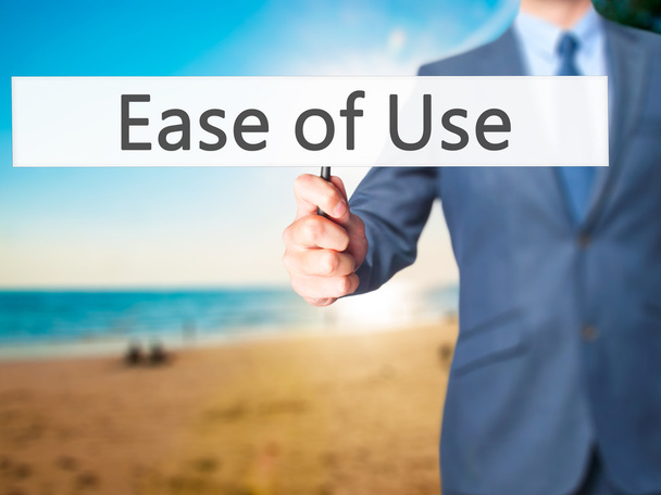 Ease of Use - Businessman hand holding sign - Photo, Image