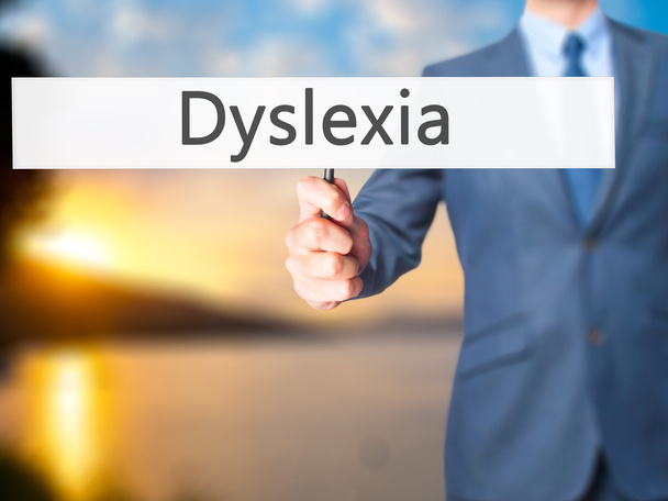 Δυσλεξία - επιχειρηματίας χέρι κρατάει πινακίδα - Φωτογραφία, εικόνα