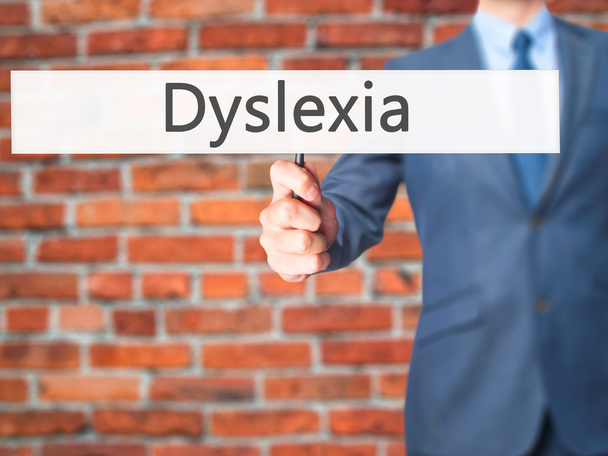 Δυσλεξία - επιχειρηματίας χέρι κρατάει πινακίδα - Φωτογραφία, εικόνα