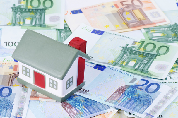 Toy house for euro banknotes as a background - Foto, imagen