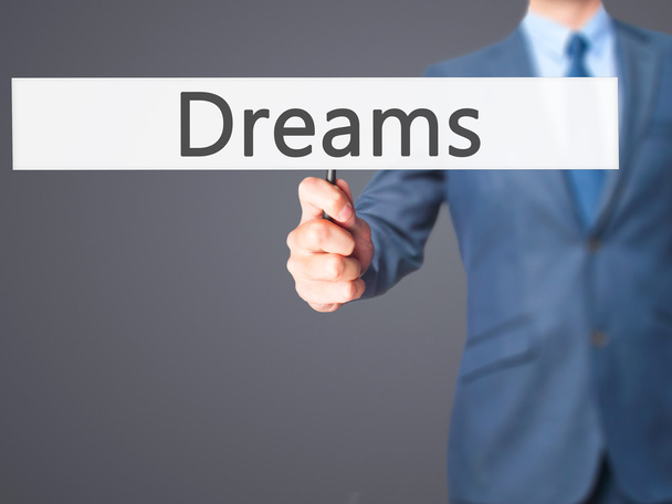 Мрії - Бізнесмен рука тримає знак
 - Фото, зображення