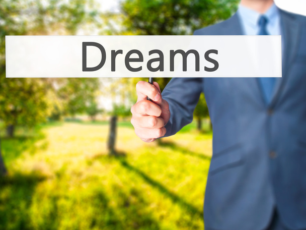 Dreams - Businessman hand handing sign
 - Фото, изображение