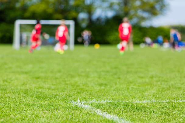 Blurred kids playing youth football match - Φωτογραφία, εικόνα